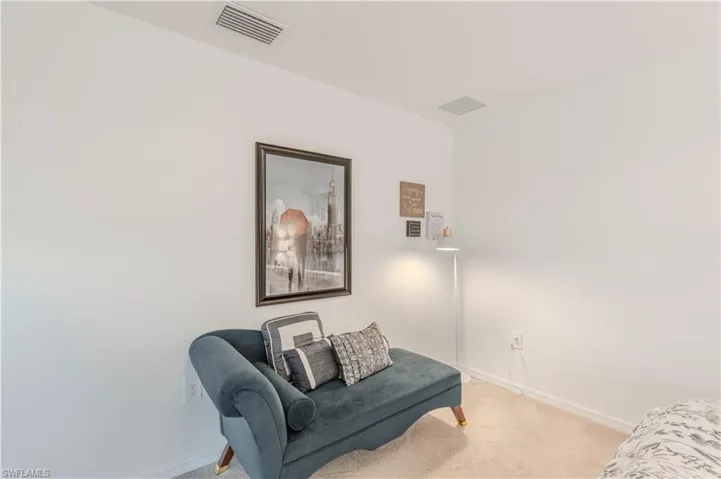 Sitting room featuring carpet flooring and baseboards