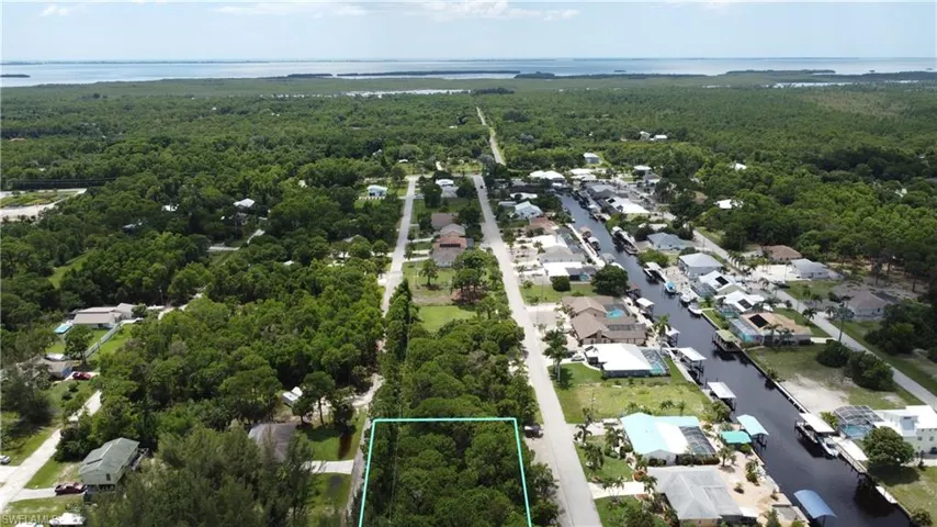 Birds eye view of property with a residential view, a forest view, and a water view