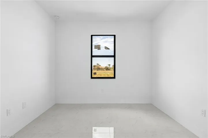 Spare room featuring light marble finish flooring