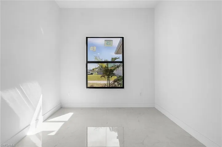 Unfurnished room with light marble finish flooring and baseboards