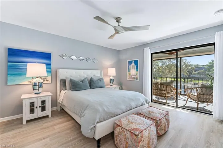 Bedroom with access to exterior, light hardwood / wood-style flooring, and ceiling fan