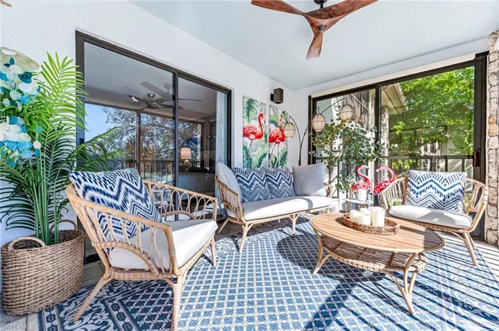 Sunroom / solarium featuring ceiling fan