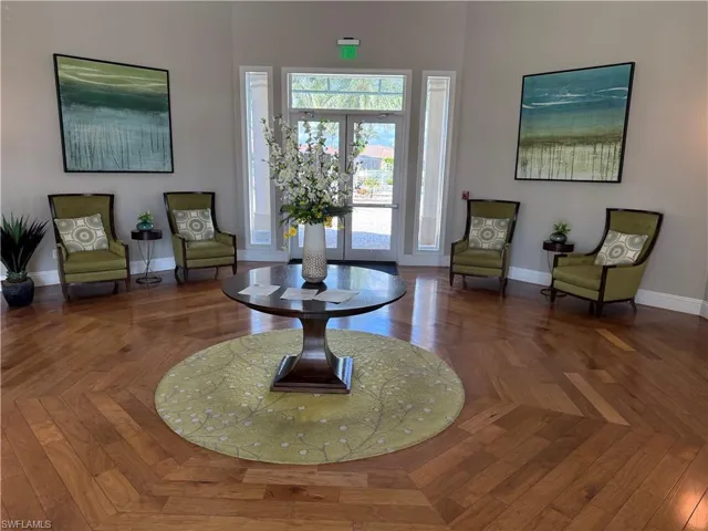 Sitting room with a high ceiling and baseboards