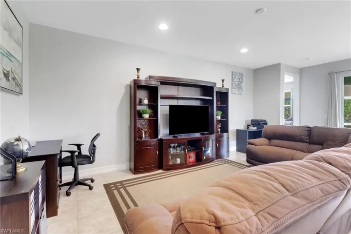 Living room featuring recessed lighting, light tile patterned floors, and baseboards