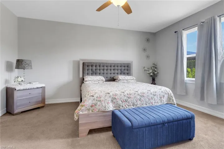 Bedroom featuring baseboards, a ceiling fan, and carpet floors