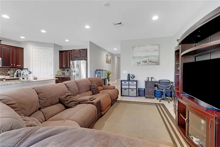 Living area with recessed lighting and visible vents