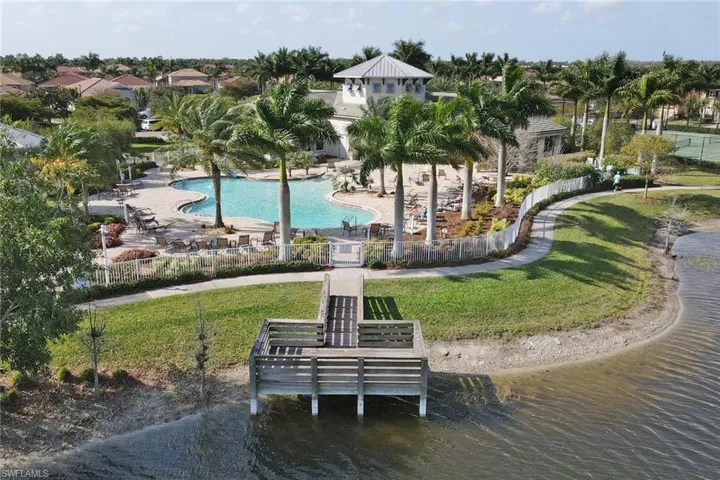 View of community with a patio area, a pool, fence, and a lawn