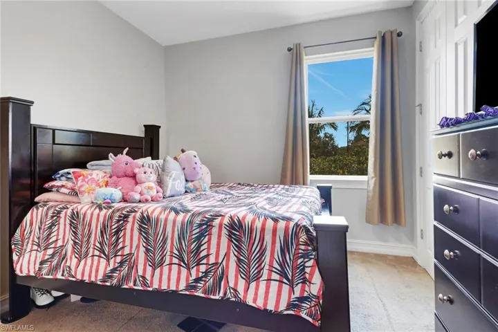Carpeted bedroom with baseboards
