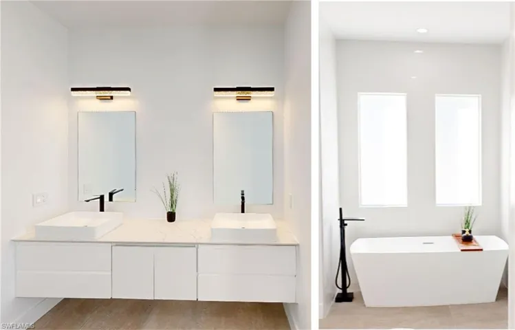 Full bath with double vanity, a sink, and a soaking tub