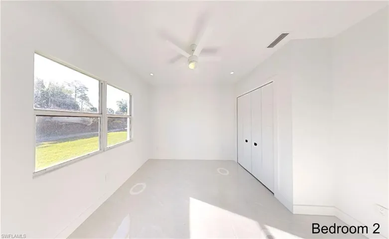 Unfurnished bedroom featuring baseboards, a closet, ceiling fan, and visible vents