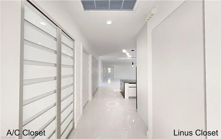 Hallway featuring visible vents and recessed lighting