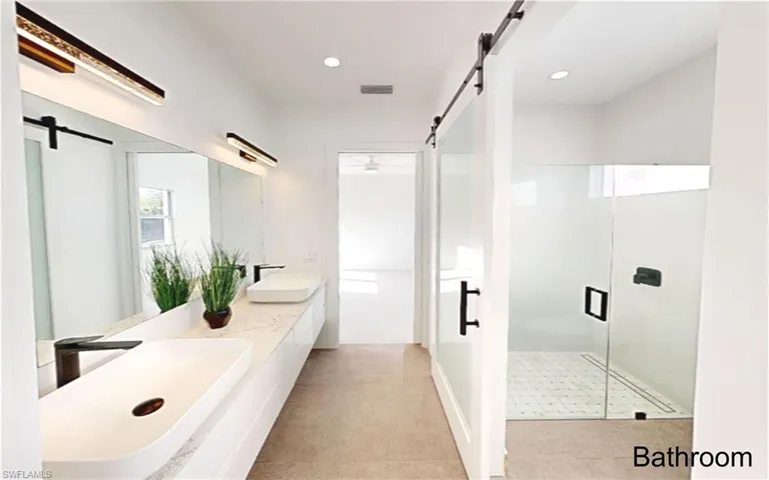 Full bathroom with visible vents, a shower stall, double vanity, recessed lighting, and a sink