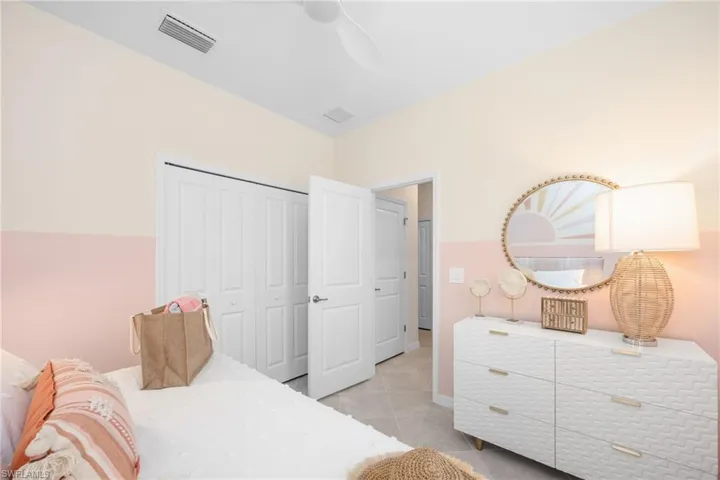 White interior doors, ceiling fan, and light-toned flooring