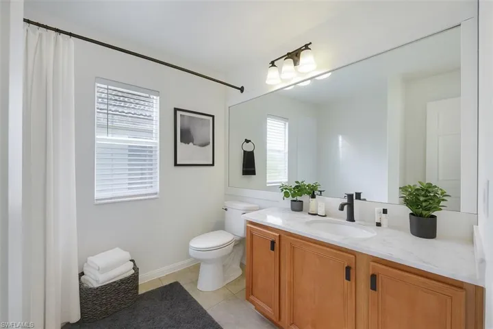 Bathroom with vanity and light tile patterned flooring