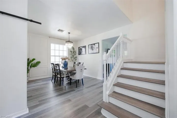 Dining space featuring light wood-style floors and stairs