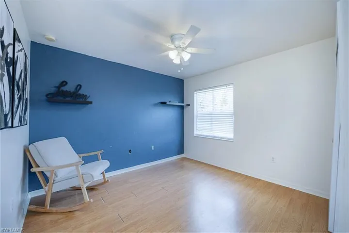 Living area featuring light wood-style flooring and a ceiling fan