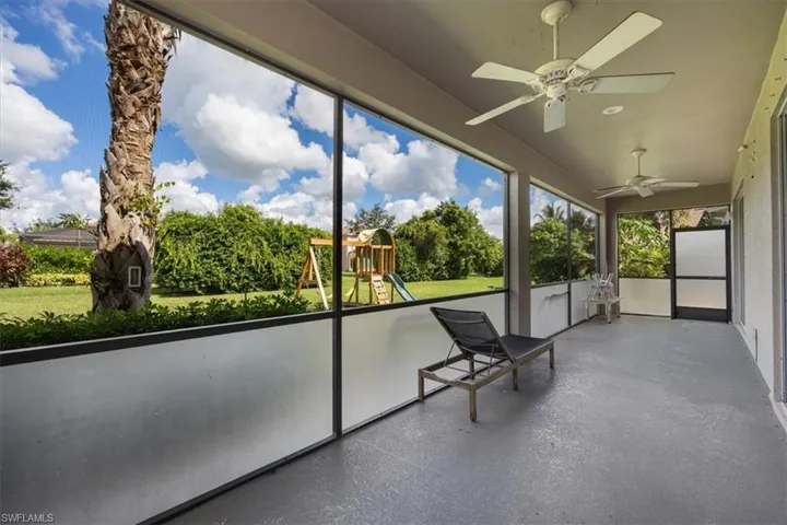 Unfurnished sunroom featuring ceiling fan
