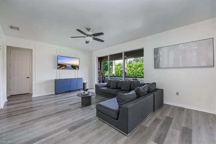 Living area featuring light wood finished floors and a ceiling fan