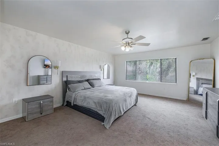 Bedroom featuring carpet and ceiling fan