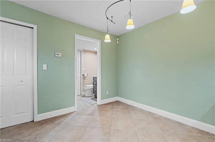 Unfurnished dining area featuring baseboards and light tile patterned floors
