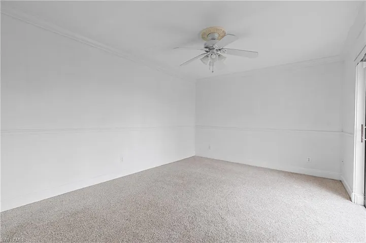 Unfurnished room with crown molding and ceiling fan