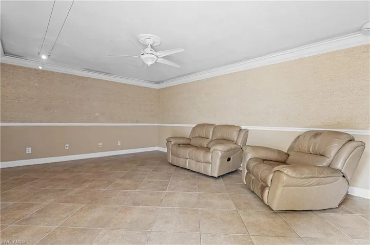 Sitting room with ceiling fan and light tile patterned flooring