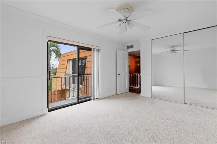 Unfurnished bedroom featuring carpet flooring, crown molding, access to exterior, a closet, and a ceiling fan