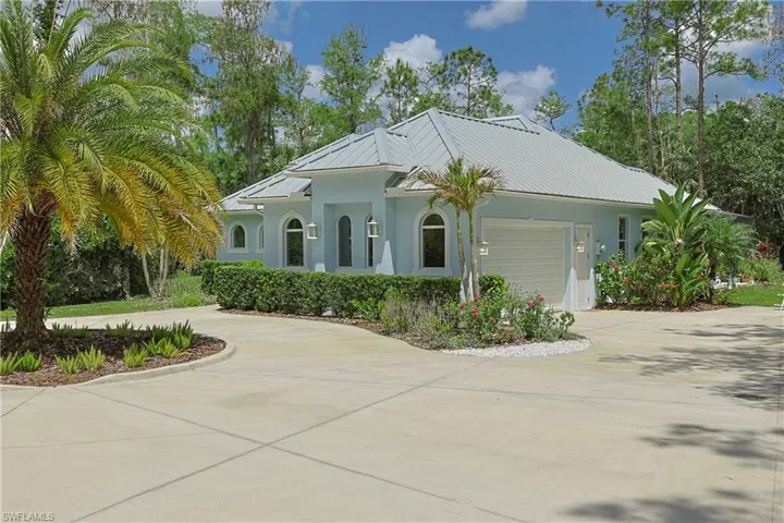 Light blue exterior with a metal roof and an integrated garage