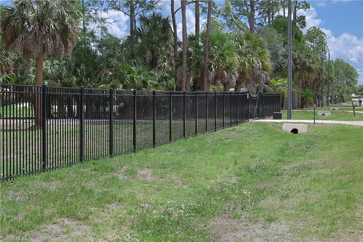 Black metal perimeter fencing defining the property line