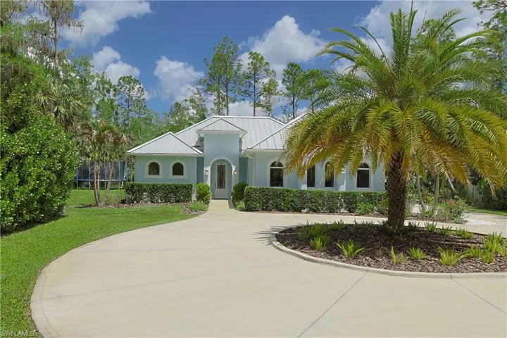 Light blue exterior with white metal roof