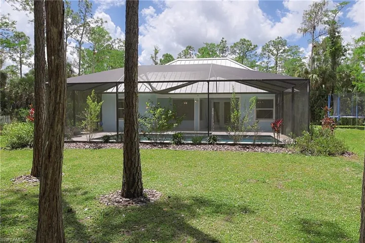 Screened-in patio enclosure featuring a swimming pool and light blue exterior siding