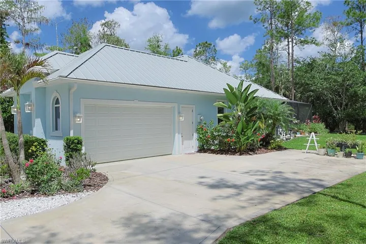 Light blue exterior with a metal roof and an arched window
