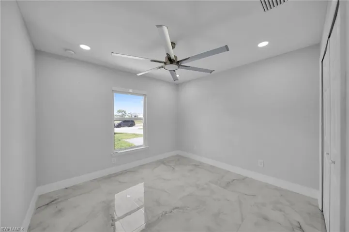 Unfurnished room with light marble finish floors, recessed lighting, and ceiling fan