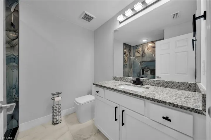 Full bath featuring vanity and a shower