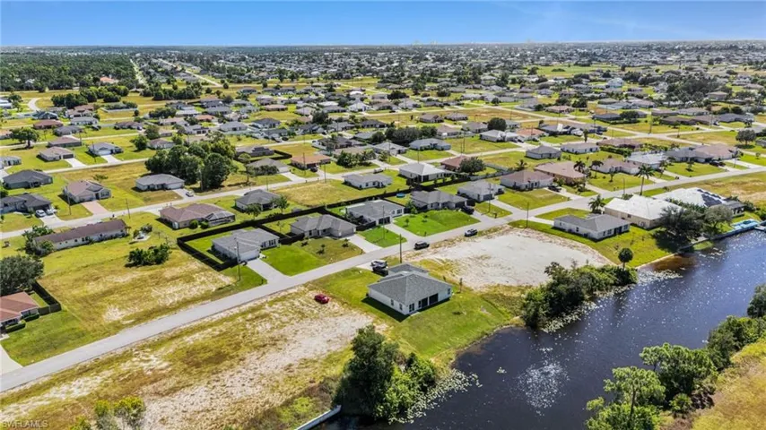 Aerial perspective of suburban area featuring a large body of water