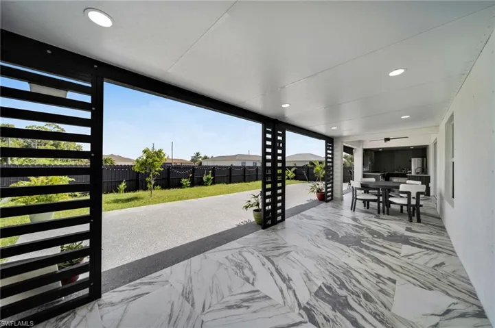 Fenced backyard with a patio area and outdoor dining area