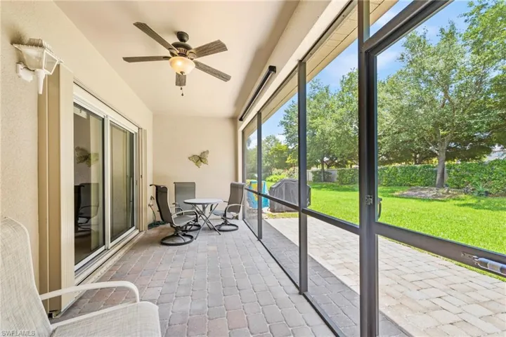 Screened lanai featuring a paver patio and ceiling fan with integrated lighting