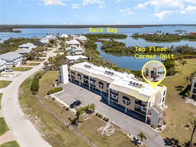 Birds eye view of property with a water view