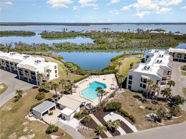 Aerial view featuring a water view and community pool