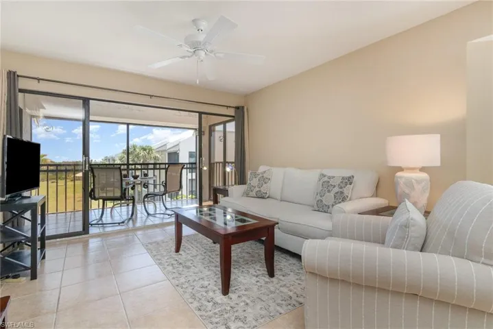 Living Area – Light tile flooring, ceiling fan, and a view of the lanai.
