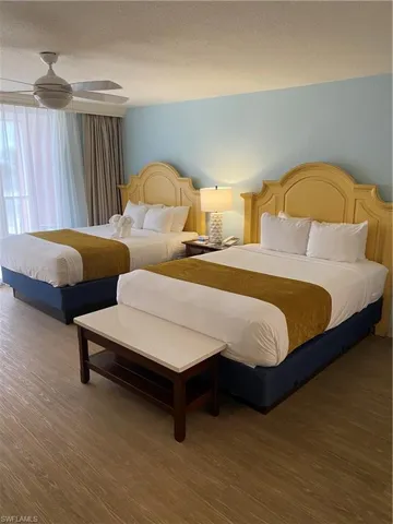 Bedroom featuring a textured ceiling, wood-type flooring, and ceiling fan