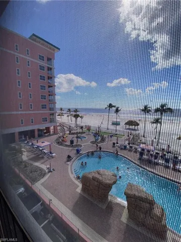 View of pool featuring a jacuzzi and a water view