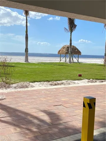 View of patio / terrace featuring a water view and a beach view