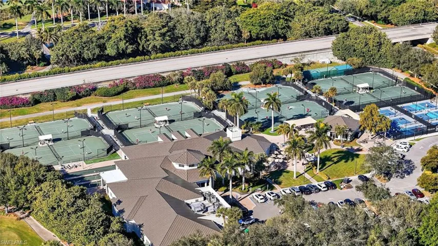 Aerial overview the Pelican Marsh Community Center, Courtside Restaurant, tennis and pickleball courts