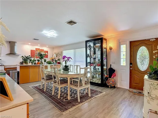 Open concept living area featuring wood-finish flooring