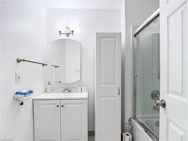 Bathroom featuring a vanity with white cabinetry, a single sink, and a chrome faucet