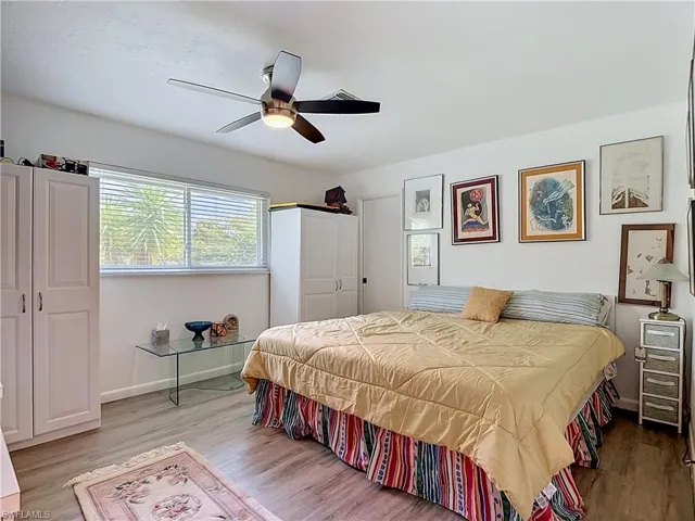 Bright interior space featuring wood-finish flooring and a ceiling fan