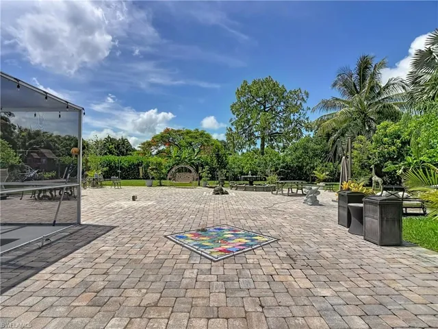 Expansive paver patio featuring a colorful mosaic inlay