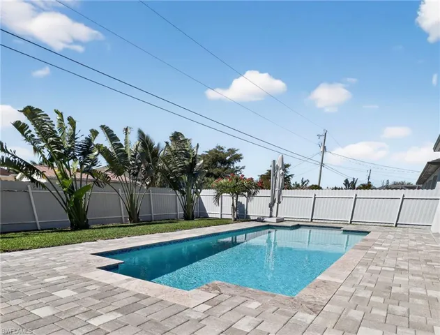View of pool featuring a fenced backyard and patio surround