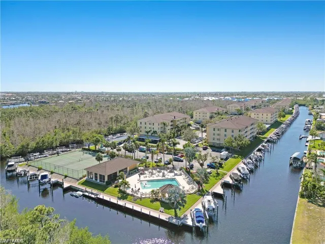 Birds eye view of property with a water view